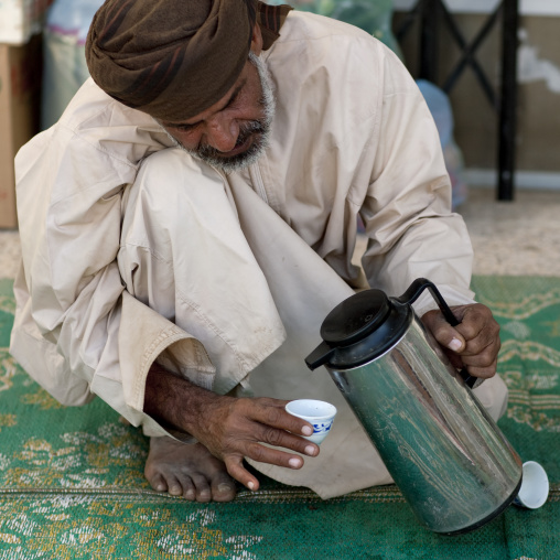 Man Squatting For Serving Coffee, Sinaw, Oman