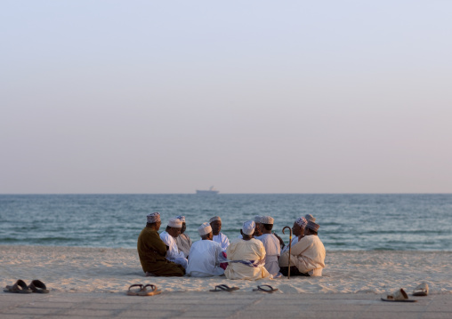 Men In Dishdasha Meeting On The Beach, Salalah, Oman