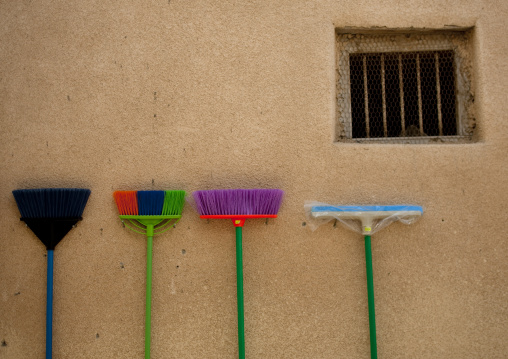 Brooms In Different Colors Leaned On The Wall Of Muscat Muttrah Souk, Oman
