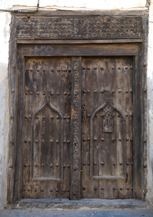 Wooden Door Carved In Arabic Stytle Of An Old House In Mirbat, Oman