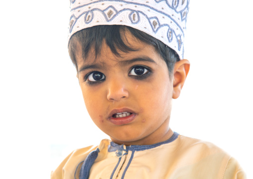 Omani boy in traditional clothing with kohl on his eyes, Ad Dakhiliyah Region, Nizwa, Oman