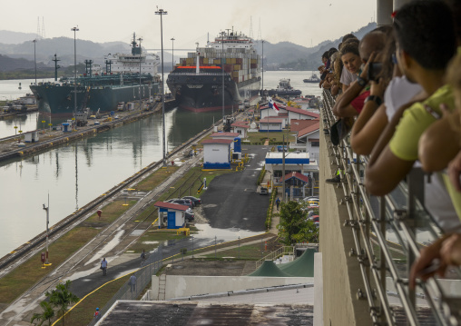 Panama, Province Of Panama, Panama City, Tourists Watching Container Ship Passing Through The Miraflores Locks In The Panama Canal
