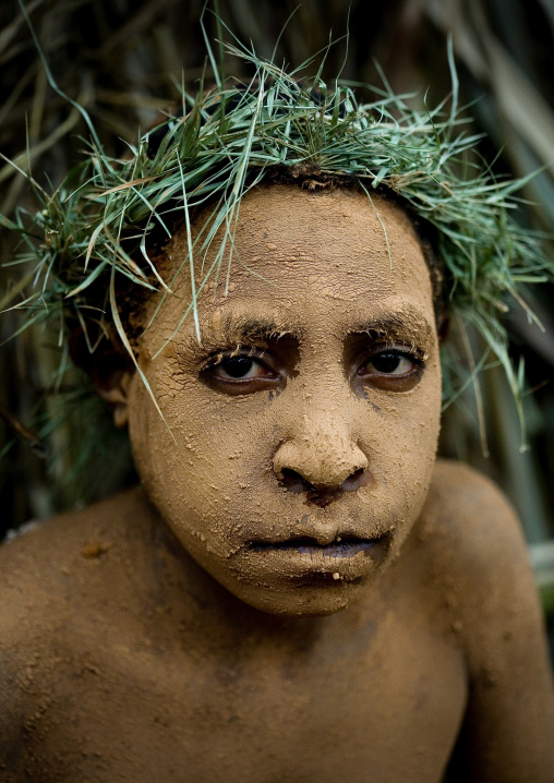 Chimbu tribe boy with a vegetal headwear during a Sing-sing ceremony, Western Highlands Province, Mount Hagen, Papua New Guinea