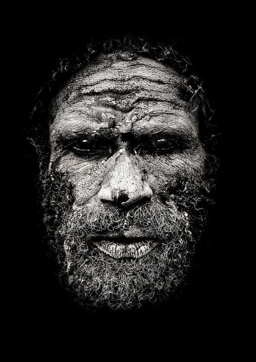 Portrait of a Chimbu tribe man with the face covered in mud, Western Highlands Province, Mount Hagen, Papua New Guinea