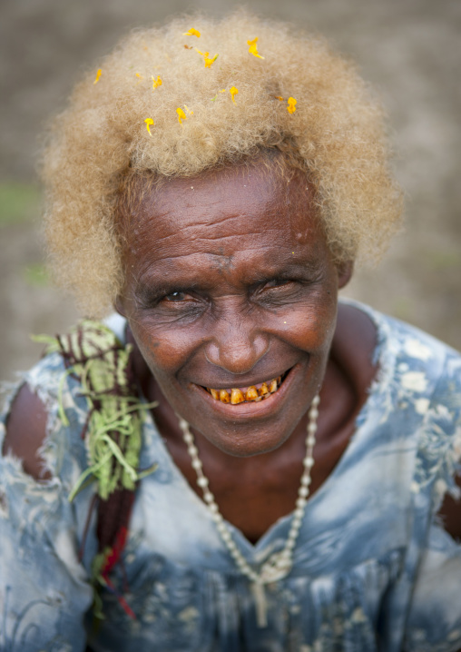 Old woman with pollens in her blonde hair, New Ireland Province, Langania, Papua New Guinea