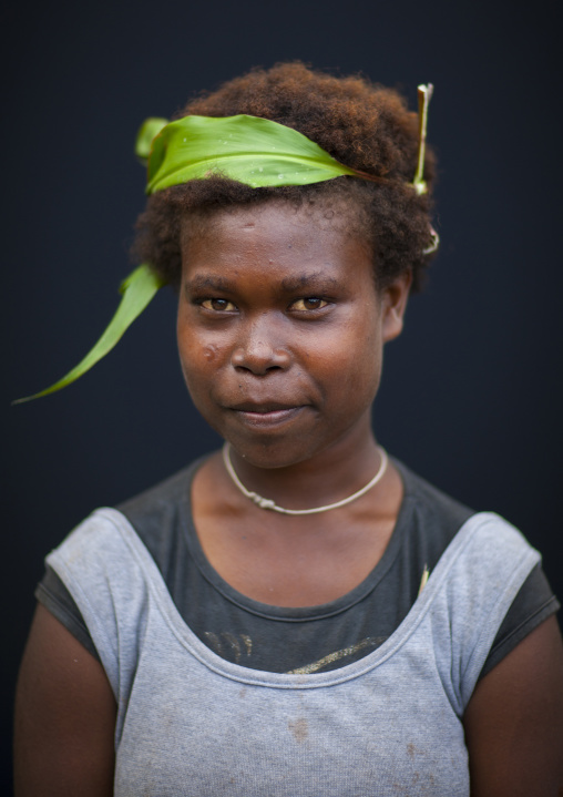 Portrait of a girl with a leaf in the hair, New Ireland Province, Langania, Papua New Guinea
