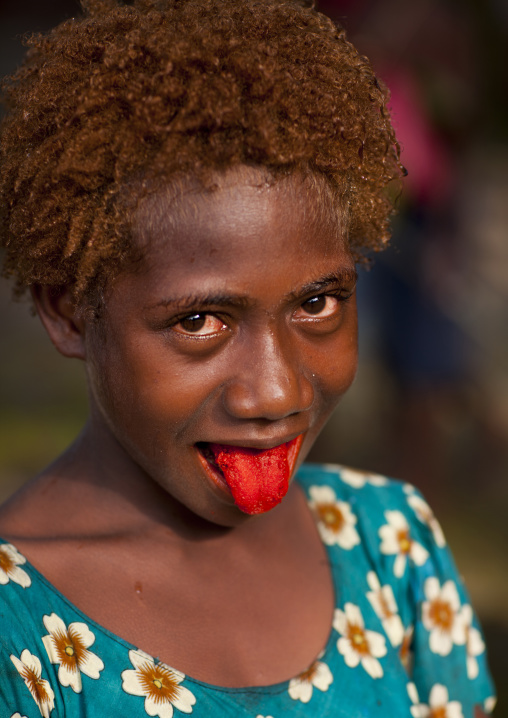 Girl with red tongue full of betel, New Ireland Province, Langania, Papua New Guinea