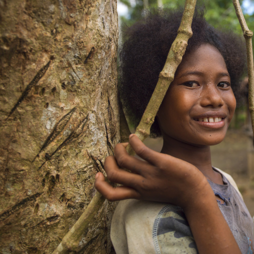 Portrait of a young girl smiling, Milne Bay Province, Trobriand Island, Papua New Guinea