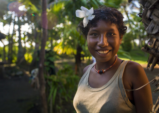 Smiling girl with flowers in the hair, Milne Bay Province, Trobriand Island, Papua New Guinea