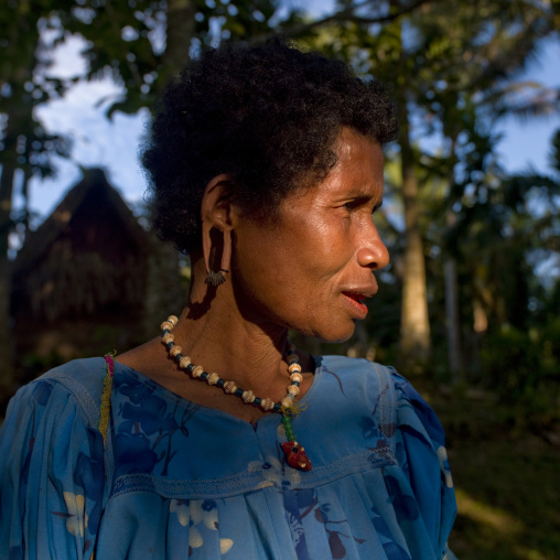 Woman wearing earrings made with turtle shells, Milne Bay Province, Trobriand Island, Papua New Guinea