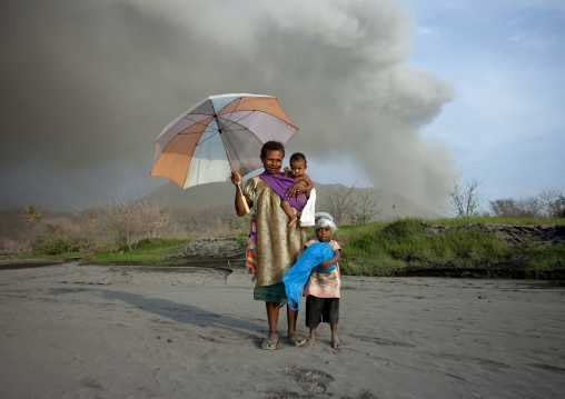 Family under a volcanic eruption in tavurvur volcano, East New Britain Province, Rabaul, Papua New Guinea