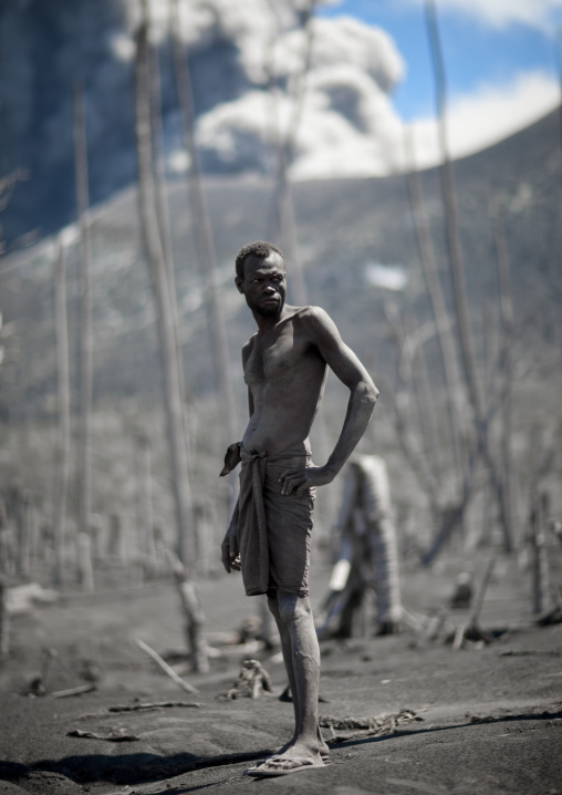 Man digging to find megapode birds eggs in Tavurvur volcano ashes, East New Britain Province, Rabaul, Papua New Guinea