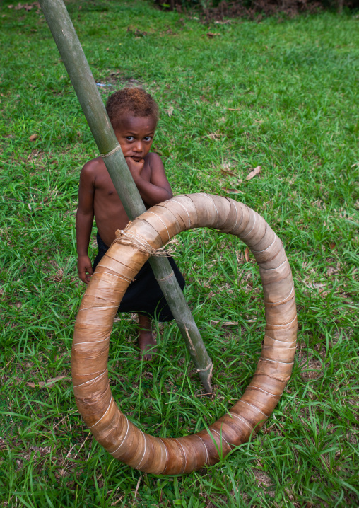 Boy with a giant traditional shell money, East New Britain Province, Rabaul, Papua New Guinea