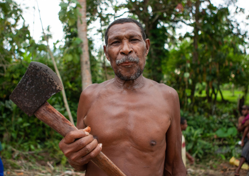 Man carving a canoe in the forest, Milne Bay Province, Alotau, Papua New Guinea