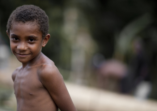 Portrait of shirtless boy, Milne Bay Province, Alotau, Papua New Guinea