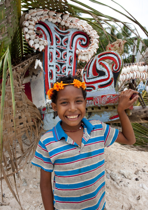 Girl in front of a kula canoe decorated with shells, Milne Bay Province, Trobriand Island, Papua New Guinea