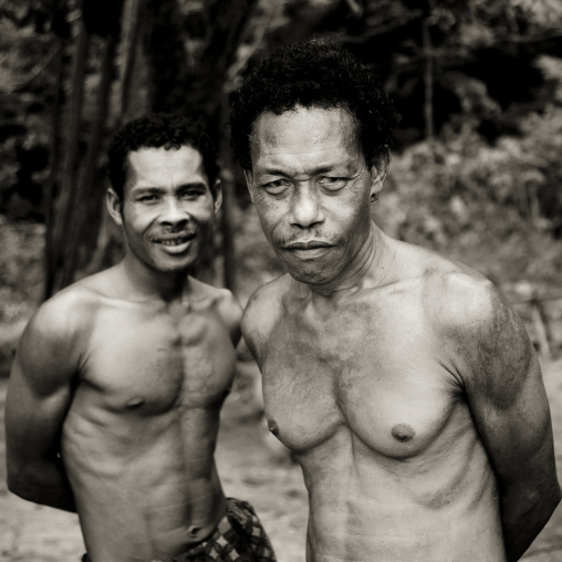 Portrait of shirtless men, Milne Bay Province, Trobriand Island, Papua New Guinea