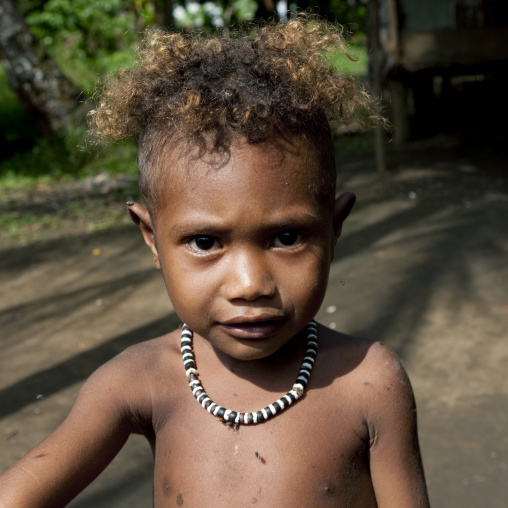 Boy with curly blonde hair, Milne Bay Province, Trobriand Island, Papua New Guinea