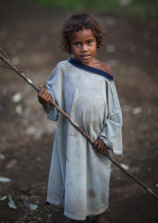Islander girl holding a stick, Milne Bay Province, Trobriand Island, Papua New Guinea