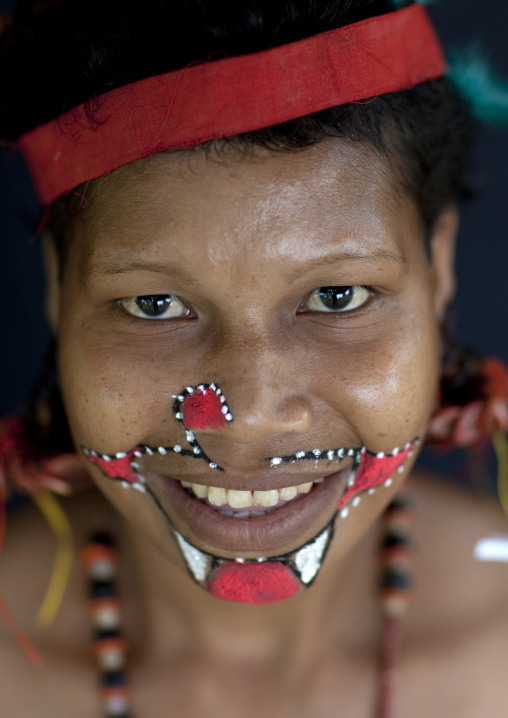 Portrait of a smiling tribal woman in traditional clothing, Milne Bay Province, Trobriand Island, Papua New Guinea