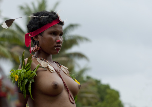 Portrait of a topless tribal woman in traditional clothing, Milne Bay Province, Trobriand Island, Papua New Guinea