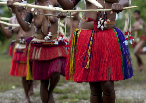 Tribal women dancers with skirts made of banana leaf and pandanus palm leaf, Milne Bay Province, Trobriand Island, Papua New Guinea