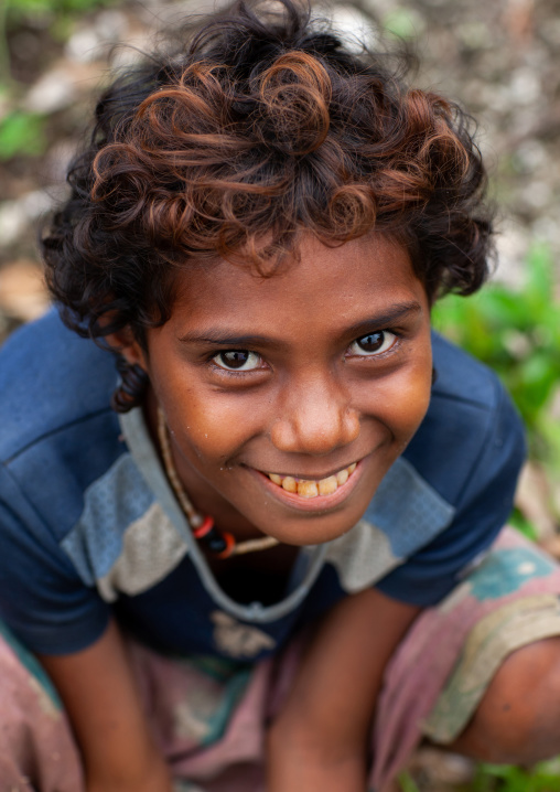 Portrait of a smiling boy with curly hair, Milne Bay Province, Trobriand Island, Papua New Guinea