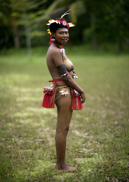 Portrait of a topless tribal woman in traditional clothing, Milne Bay Province, Trobriand Island, Papua New Guinea