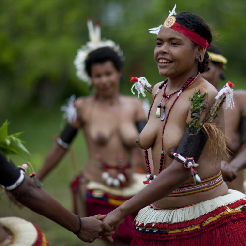 Tribal topless women dancing during a sing-sing, Milne Bay Province, Trobriand Island, Papua New Guinea