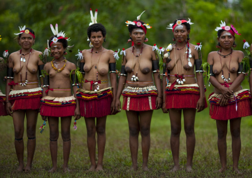 Portrait of topless tribal women in traditional clothing, Milne Bay Province, Trobriand Island, Papua New Guinea