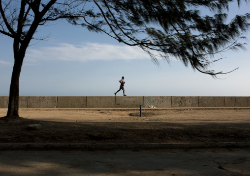Man running along the sea, National Capital District, Port Moresby, Papua New Guinea