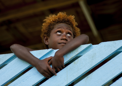Boy standing at blue balcony, Autonomous Region of Bougainville, Bougainville, Papua New Guinea