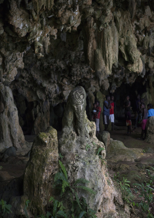 People in front of the entrance of Momuni sacred cave, Autonomous Region of Bougainville, Bougainville, Papua New Guinea
