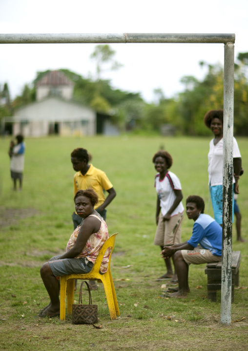 Women sit on a football field, Autonomous Region of Bougainville, Bougainville, Papua New Guinea