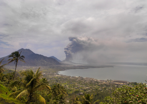 Volcanic eruption in Tavurvur volcano with the bay view, East New Britain Province, Rabaul, Papua New Guinea
