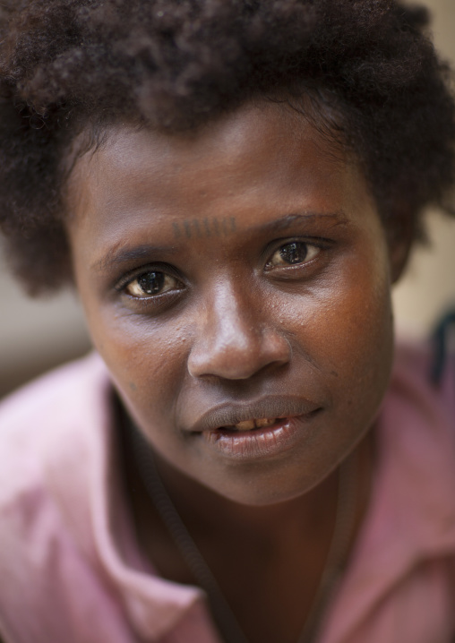Young woman with tattoos on the face, New Ireland Province, Kapleman, Papua New Guinea