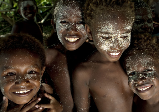 Smiling boys with sand on the face, New Ireland Province, Langania, Papua New Guinea