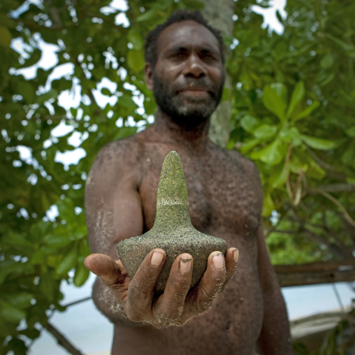 Man showing a magic stone, New Ireland Province, Laraibina, Papua New Guinea