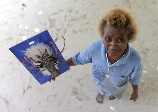Woman showing a lobster, New Ireland Province, Laraibina, Papua New Guinea