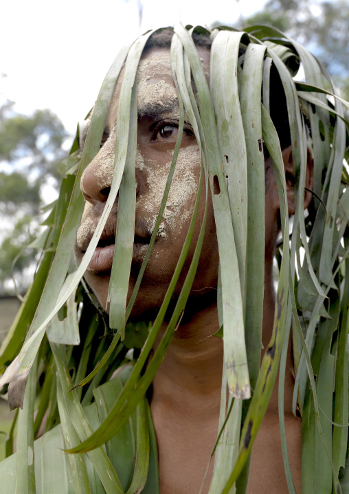 Portrait of a Chimbu tribe man with vegetal headwear during a sing sing, Western Highlands Province, Mount Hagen, Papua New Guinea