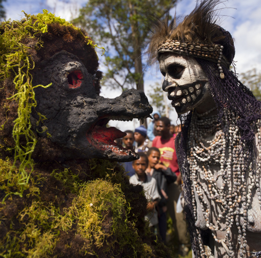 Skeleton tribe woman and giant rat character during a sing sing, Western Highlands Province, Mount Hagen, Papua New Guinea