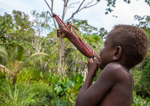 Boy chasing birds, New Ireland Province, Laraibina, Papua New Guinea