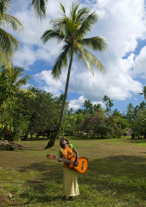 Girl playing guitar, Milne Bay Province, Trobriand Island, Papua New Guinea