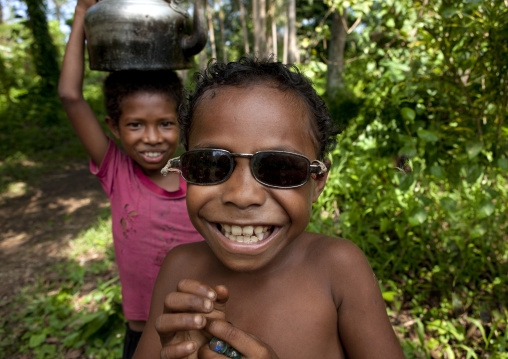 Boy wearing sunglasses, Milne Bay Province, Trobriand Island, Papua New Guinea