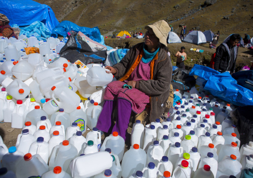 Woman Selling Holly Water At Qoyllur Riti Festival, Ocongate Cuzco, Peru