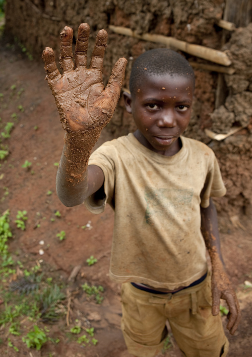 Batwa tribe boy waving hand, Western Province, Cyamudongo, Rwanda