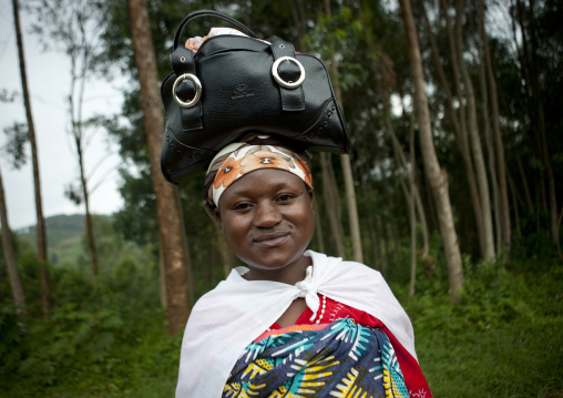 Batwa woman carrying her handgag on her head, Western Province, Cyamudongo, Rwanda