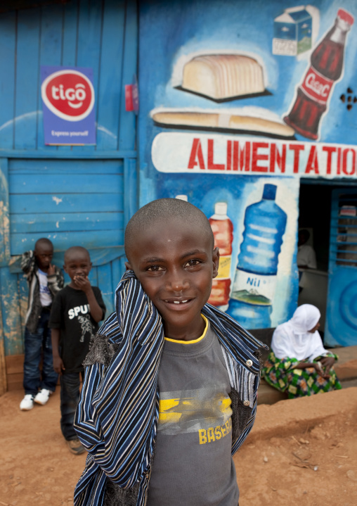 Rwandan boy in front of a shop mural, Kigali Province, Kigali, Rwanda