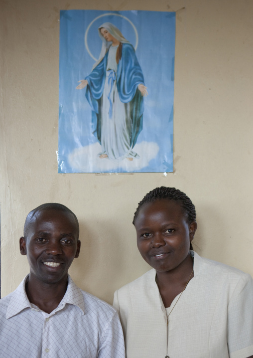Clementine and innocent under a virgin mary poster, Kigali Province, Kigali, Rwanda