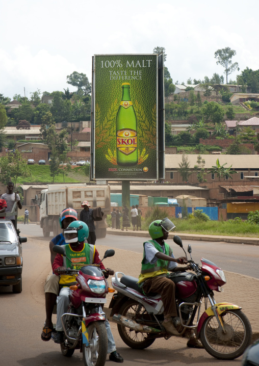 Moto taxis in front of a giant beer billboard, Kigali Province, Kigali, Rwanda